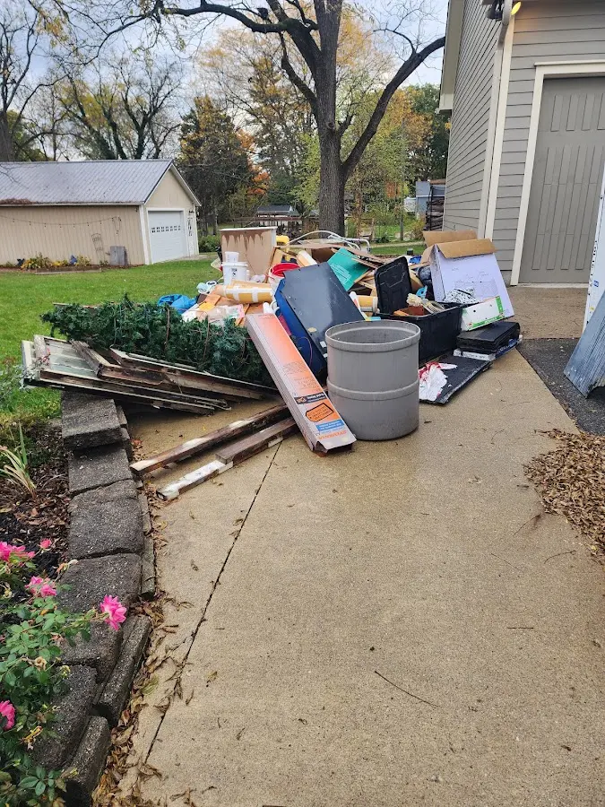 Dumpster being loaded with debris for Estate Cleanout Dumpster Rental in Savannah